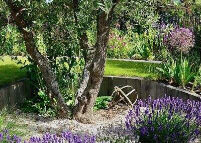 Mediterranean style garden with steep slope and waterfall